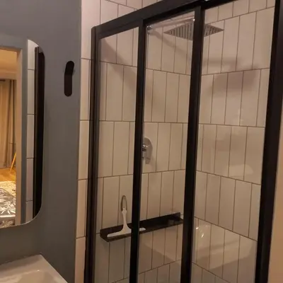 a shower with a glass door in a bathroom at Blouberg Studio in Cape Town