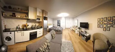 a large living room with a kitchen and a living room at Blouberg Studio in Cape Town