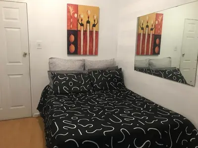a bedroom with a bed and two paintings on the wall at 11 on Orange in Cape Town