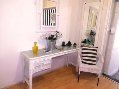 a white desk with a chair and a mirror at 11 on Orange in Cape Town