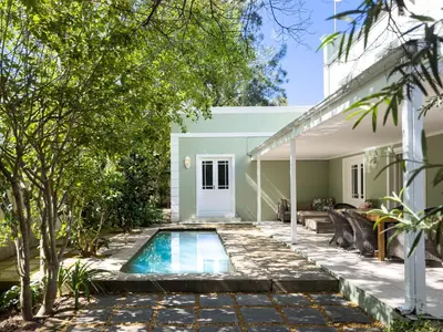a swimming pool in the backyard of a house at The hidden Retreat on Haumann in Franschhoek