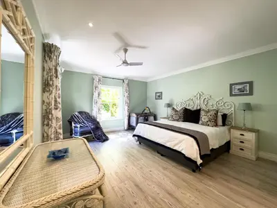 a bedroom with a bed and a table in it at The hidden Retreat on Haumann in Franschhoek