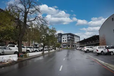 an empty street with cars parked on the side of the road at Tranquil Loft Design and Underground Parking in Stellenbosch