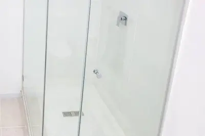 a shower with a glass door in a bathroom at Tranquil Loft Design and Underground Parking in Stellenbosch