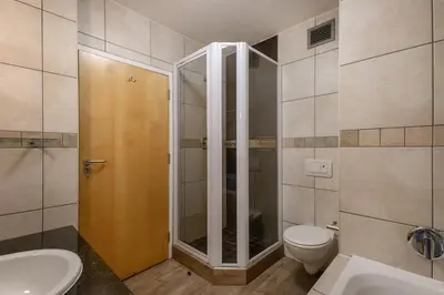a bathroom with a shower and a toilet and a sink at Beachfront Luxury Apartment - Hibernian Towers 309 Strand - Self Catering in Cape Town