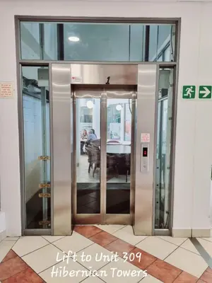 an elevator in a building with an open door at Beachfront Luxury Apartment - Hibernian Towers 309 Strand - Self Catering in Cape Town