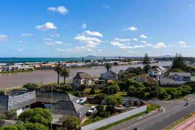 arial view of a town with a river and houses at Burmeister 606 - Top Floor 2 Bedroom Apartment with Ocean Views - Onsite Parking in Cape Town