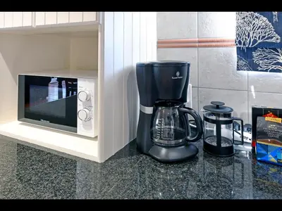a coffee maker next to a microwave on a counter at Sunflower Villa in Franschhoek in Franschhoek