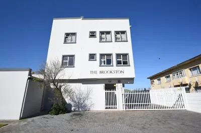 a white building with a sign that reads the repository at The Brookston in Cape Town