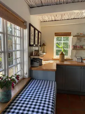 a kitchen with a checkered rug on the floor at 13 On Vigne in Greyton