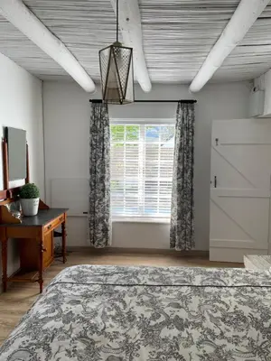 a bedroom with a large bed and a window at 13 On Vigne in Greyton
