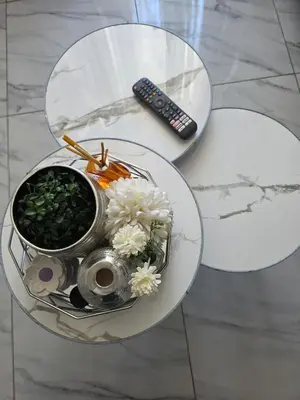 a glass table with a bowl of flowers and a remote control at Elite Escape in Cape Town