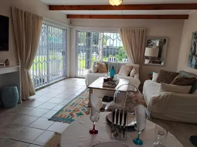 a living room with a couch and a table at Milky Way in Hermanus