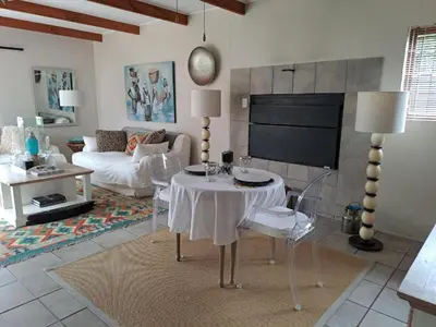 a living room with a table and a couch at Milky Way in Hermanus