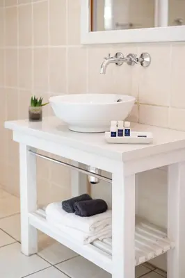 a white bathroom vanity with a sink on it at Leipzig Country House & Winery in Nuy