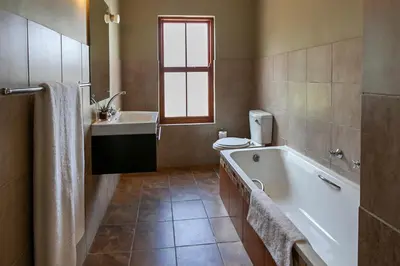 a bathroom with a tub and a toilet and a sink at Leipzig Country House & Winery in Nuy