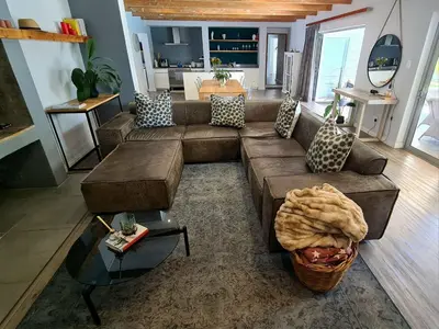 a living room with a couch and a table at Central Stellenbosch Home (4 bed, pool & inverter) in Stellenbosch