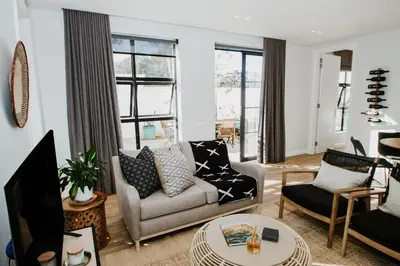 a living room with a couch and a tv at Quiet Hideaway in Somerset West