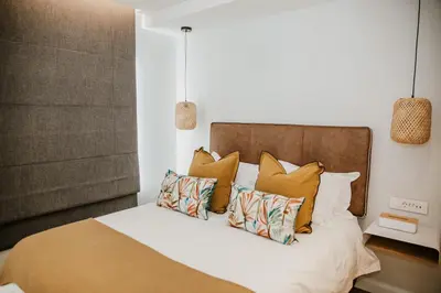 a bedroom with a bed with pillows on it at Quiet Hideaway in Somerset West