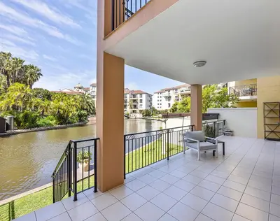 a balcony with a view of a river at Capri On Lake 101 The Island Club in Cape Town