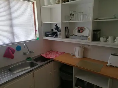 a kitchen counter with a sink and a window at HARTSRUS in Kleinmond