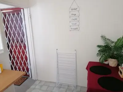 a white room with a door and a plant at HARTSRUS in Kleinmond