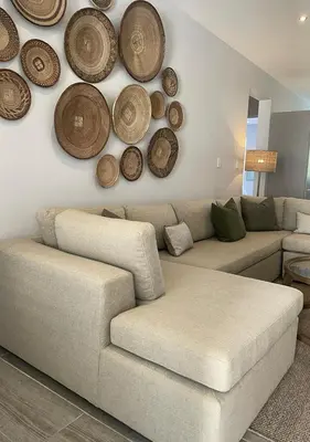a living room with a couch and wooden plates on the wall at Franschhoek Mountain Views in Franschhoek