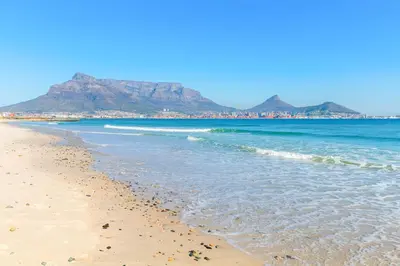 a sandy beach with mountains in the background at Lagoon Beach 29A in Cape Town