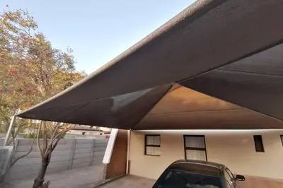 a car parked under a black awning on a house at Two bedroom flatlet in Panorama in Cape Town