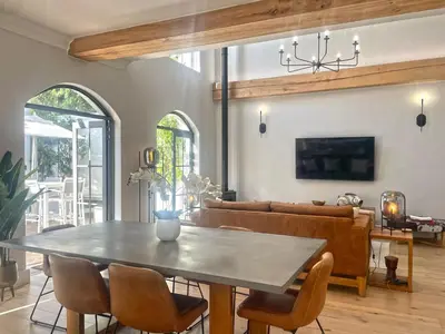 a dining room with a table and chairs at 2 Riverside Oaks in Franschhoek