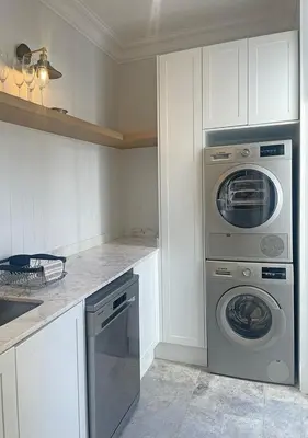 a kitchen with a washing machine and a washer and dryer at 2 Riverside Oaks in Franschhoek