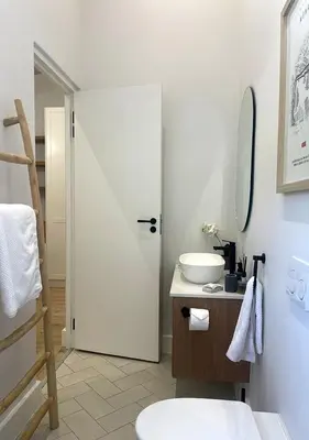 a bathroom with a white toilet and a sink at 2 Riverside Oaks in Franschhoek