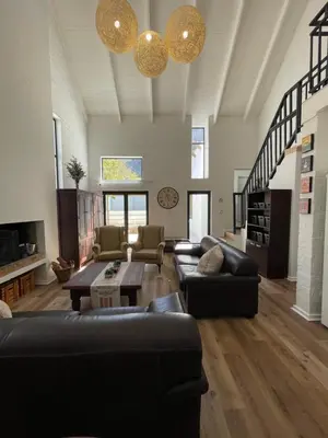 a large living room with couches and a table at Fynbos Feniks Family House in Voëlklip in Hermanus