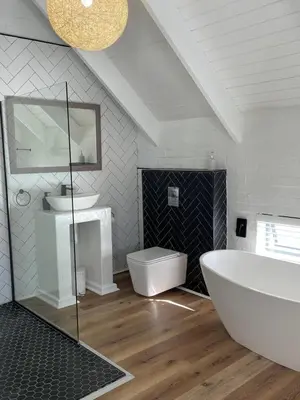 a bathroom with a large white tub and a sink at Fynbos Feniks Family House in Voëlklip in Hermanus