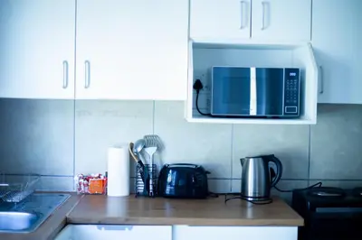 a kitchen with a counter top with a microwave at Meah lane , TableView in Cape Town