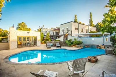 a swimming pool in the backyard of a house at Villa Luisa: Sun-filled hidden gem with Pool. in Cape Town