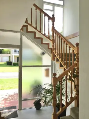 a staircase in a house with a plant next to it at Lala Panzi - Grotto Beach, Voëlklip in Hermanus