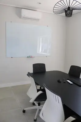 an office with a black table and white chairs at Digital Nomad's Nest, Somerset West in Cape Town