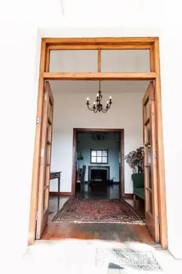 an open doorway into a room with a chandelier at La Bri Guesthouse in Rawsonville
