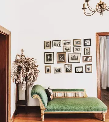 a green couch in a room with pictures on the wall at La Bri Guesthouse in Rawsonville