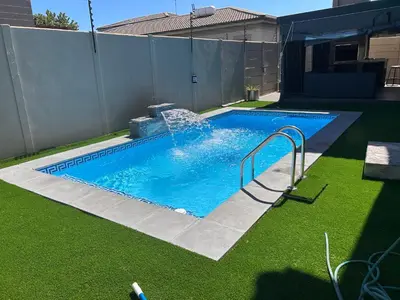 a swimming pool with a water slide in a yard at Enclaves Villa in Cape Town