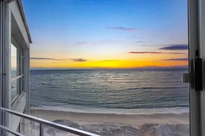 a view of the ocean from a balcony at Seaside Sunsets in Strand