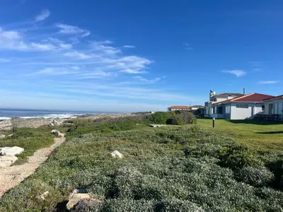 a house on the beach next to the ocean at #FiftySeven in Hermanus