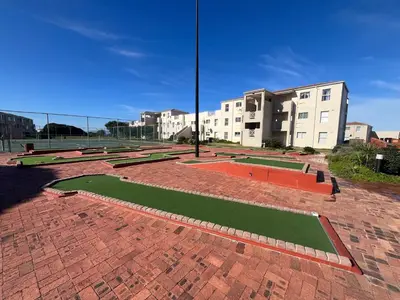 a brick walkway with grass in front of a building at #FiftySeven in Hermanus