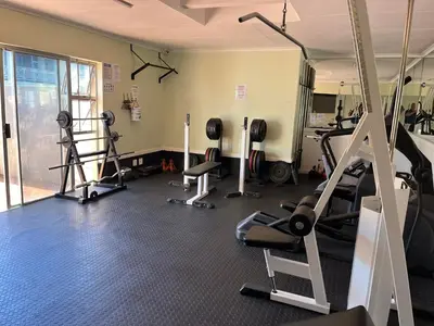 a gym with several treadmills and exercise machines at #FiftySeven in Hermanus