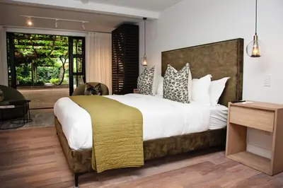 a bedroom with a large bed with white sheets and pillows at Paarl Hideaway in Paarl