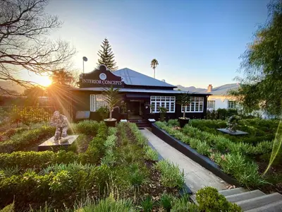 a building with a garden in front of it at Paarl Hideaway in Paarl