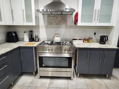 a kitchen with a stainless steel stove top oven at Cape Town gem 
