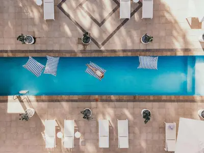 an overhead view of a pool with white tables and chairs at The Doolhof Country House in Wellington