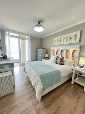 a bedroom with a large white bed in a room at Portico 705 in Cape Town